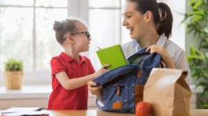 mom and daughter preparing backpack for school